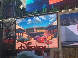 Disney cartoons playing on the marquee outside of the Disney Store